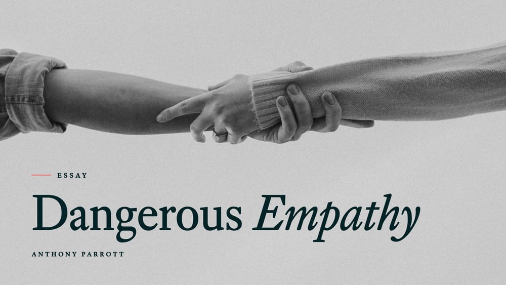 Black-and-white photo of one person gripping another person's forearm, with the title Dangerous Empathy