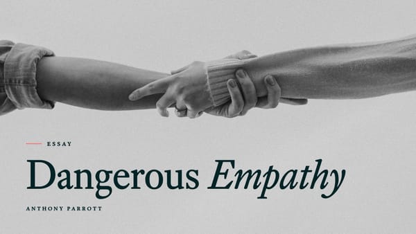 Black-and-white photo of one person gripping another person's forearm, with the title Dangerous Empathy